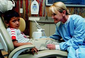 It gets better: Dr. Denise Habjan leans in to comfort an unhappy 5-year-old Valentin Ramirez for dental treatment in one of Tomorrow