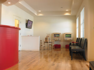 Welcoming reception space with activity area for children.