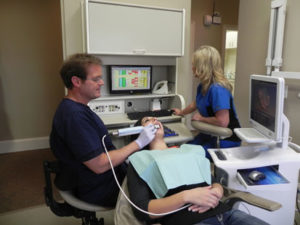 Dr. Steven Porter scans, designs, and seats same-day crowns with E4D software while assistant Julie Gillis schedules and accesses Dentrix in this paperless operatory.