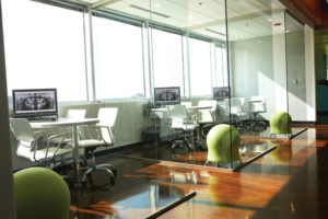 The practice incorporates many creative elements, including ultra contemporary apple green stools that are fully visible behind the glass walls of the consultation areas.