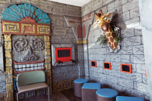 Giraffe poking its head out of the wall.