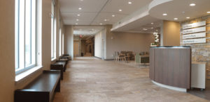 The emphasis on serene earth tones and simple, natural lines is carried through in the colors and fabrics of the upholstered chairs and also in the beauty of the rustic bench seating.