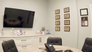 The large consultation room contains a round table and several matching chairs, giving patients private, one-on-one time they need to comfortably and confidentially discuss their dental needs with the doctor and appropriate staff.